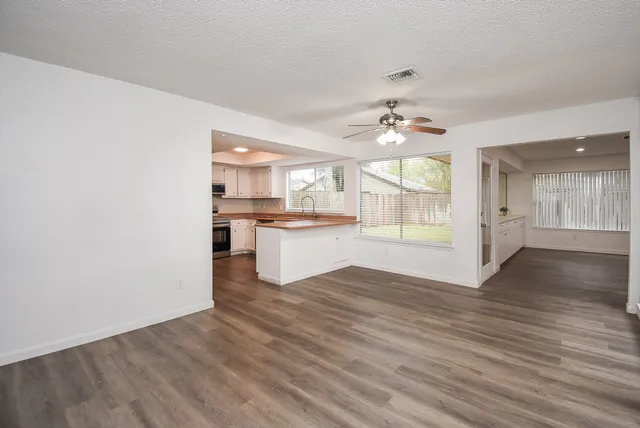 a view of a kitchen with wooden floor and a kitchen