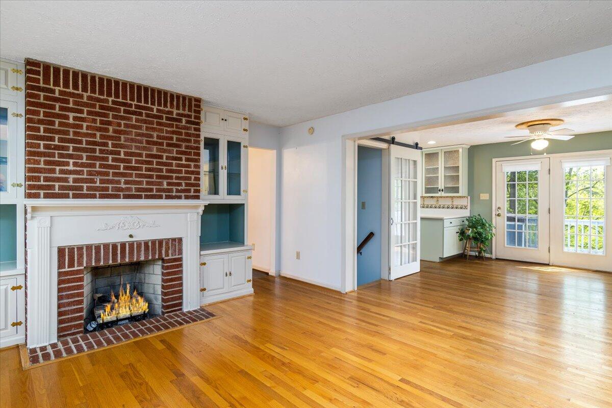 264 Pine Knob Circle Moneta, VA 24121 - Photo 16 of 67 a view of empty room with wooden floor and fireplace