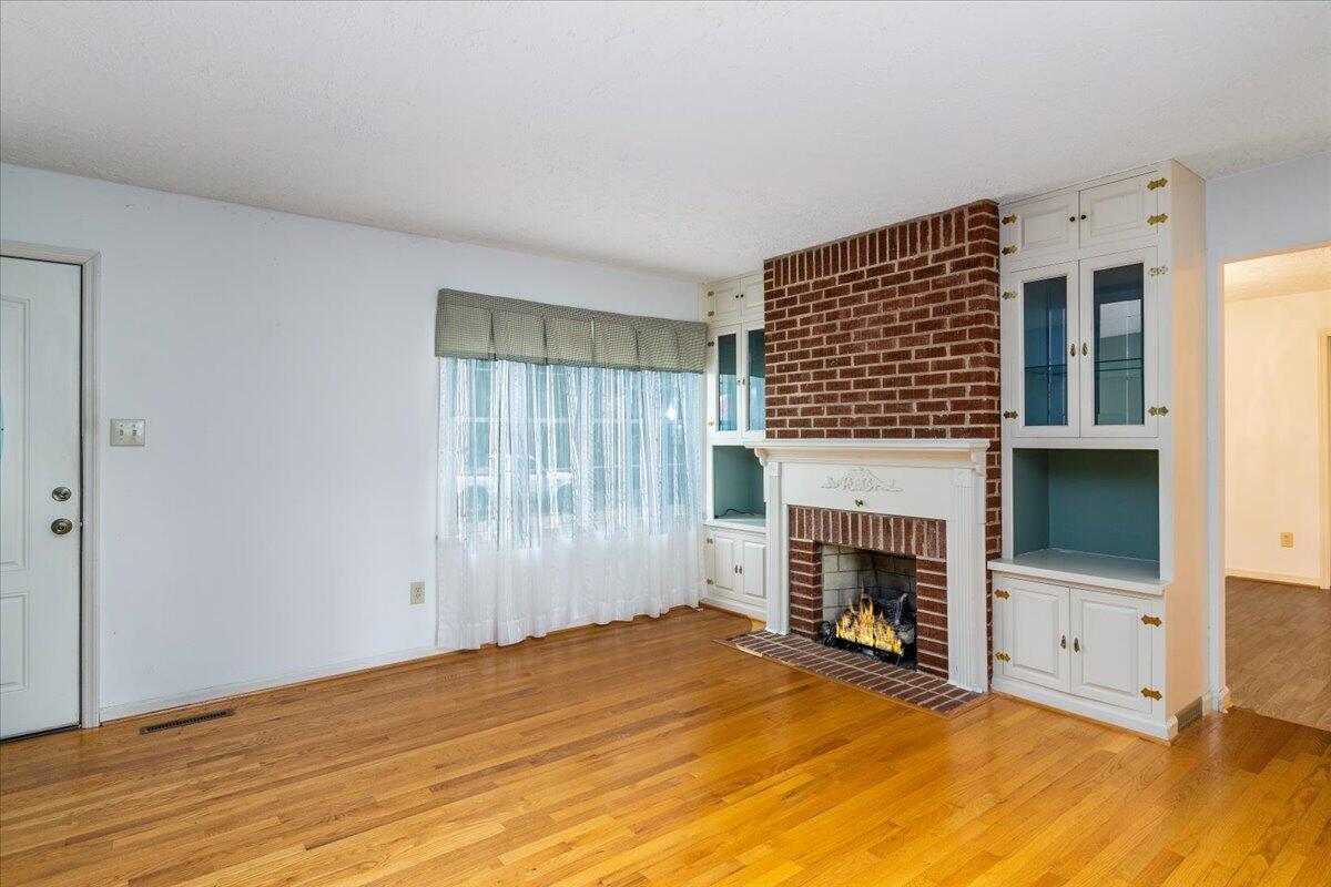 264 Pine Knob Circle Moneta, VA 24121 - Photo 17 of 67 a view of empty room with fireplace and wooden floor
