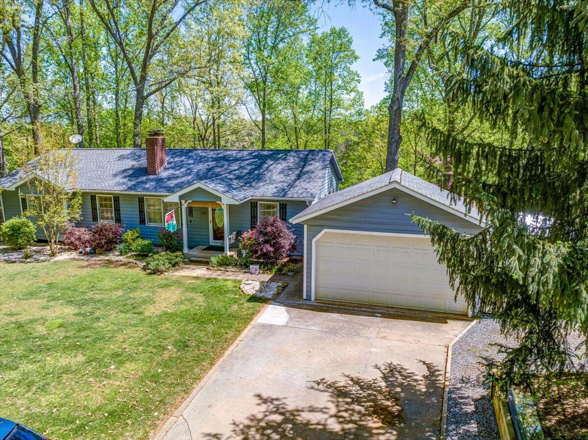 264 Pine Knob Circle Moneta, VA 24121 - Photo 3 of 67 a front view of a house with a garden and trees