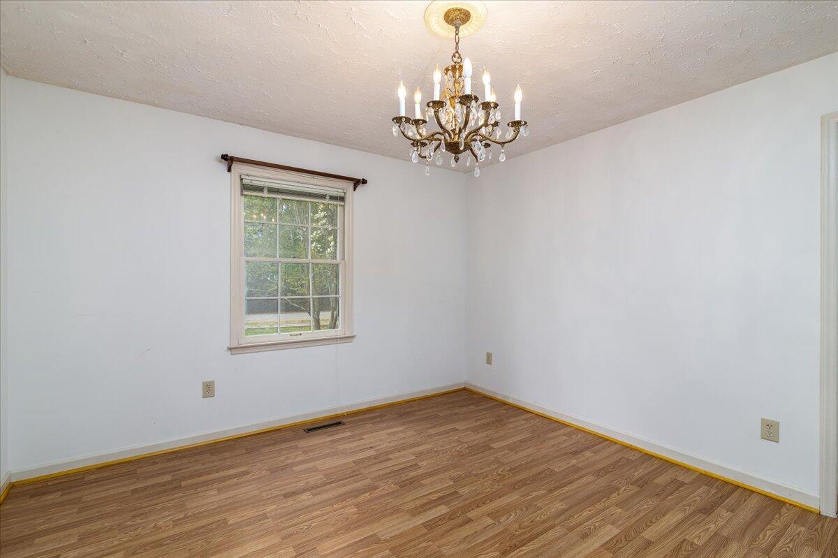264 Pine Knob Circle Moneta, VA 24121 - Photo 31 of 67 a view of a room with wooden floor chandelier and windows