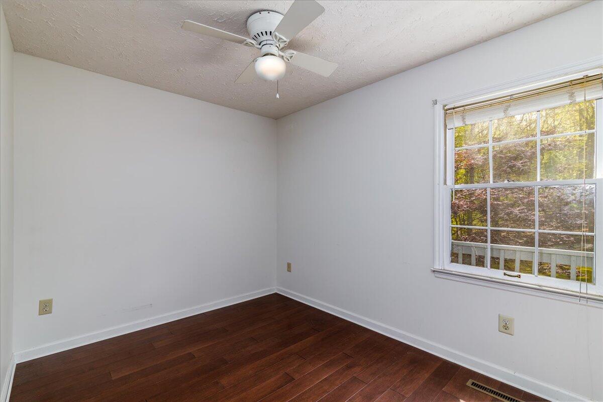 264 Pine Knob Circle Moneta, VA 24121 - Photo 35 of 67 an empty room with wooden floor and windows