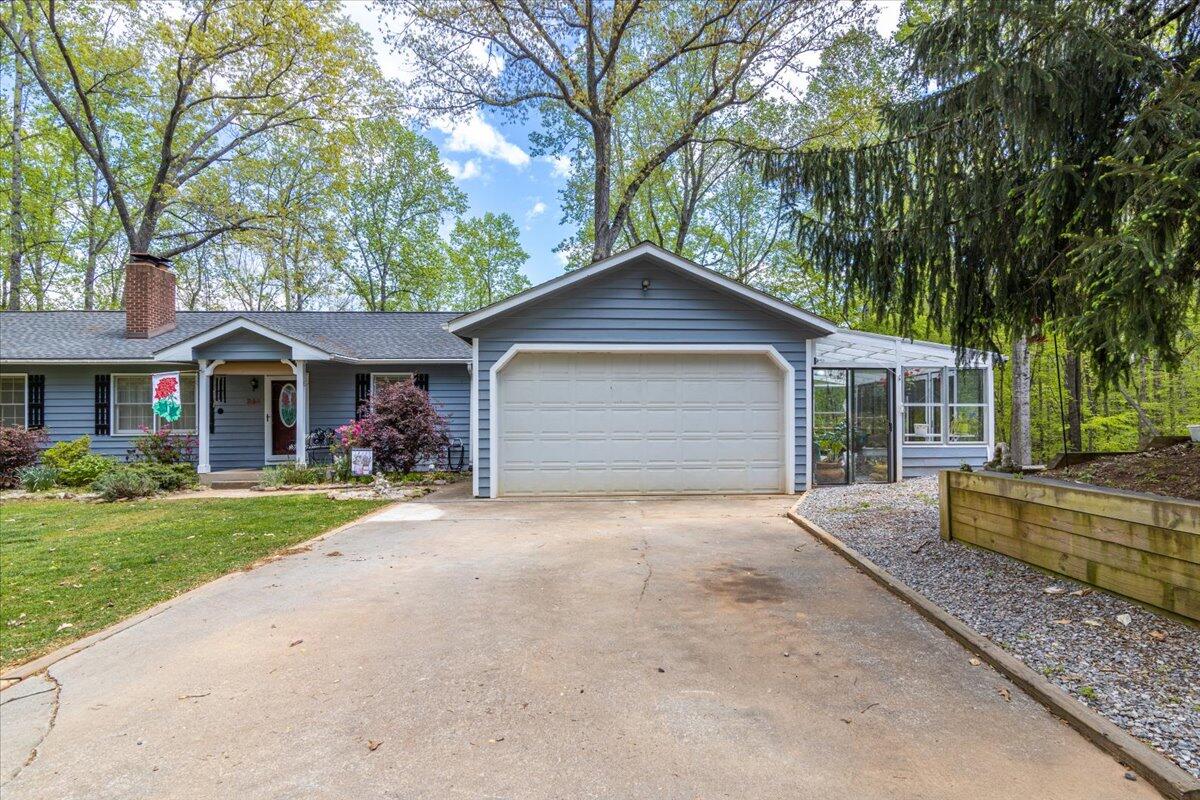 264 Pine Knob Circle Moneta, VA 24121 - Photo 4 of 67 a front view of a house with a yard and garage