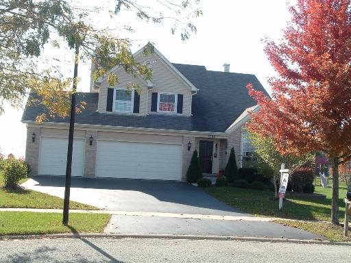 2790 Miller Road Geneva, IL 60134 - Photo 1 of 1 a front view of a house with a garden