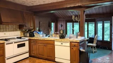 a kitchen with a stove a sink and cabinets