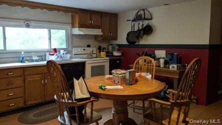 22 Old Mill Road Poughkeepsie, NY 12603 - Photo 15 of 18 a kitchen with a table chairs and a refrigerator
