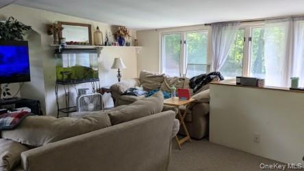 22 Old Mill Road Poughkeepsie, NY 12603 - Photo 18 of 18 a living room with furniture and a flat screen tv
