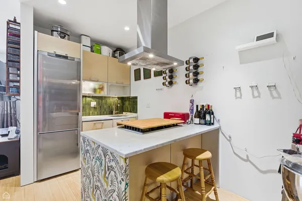 a kitchen with stainless steel appliances a refrigerator and a stove