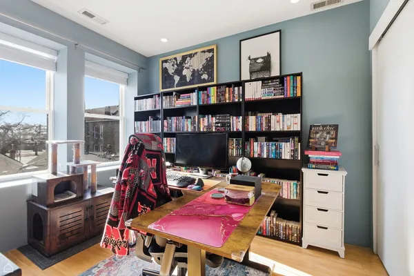 a view of a workspace with bookshelf