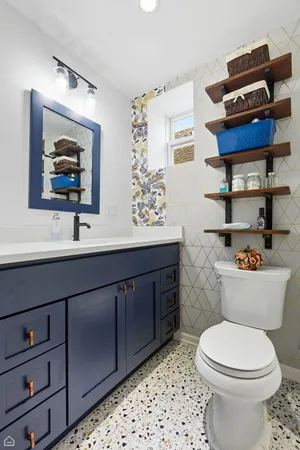 a bathroom with a toilet a sink and mirror