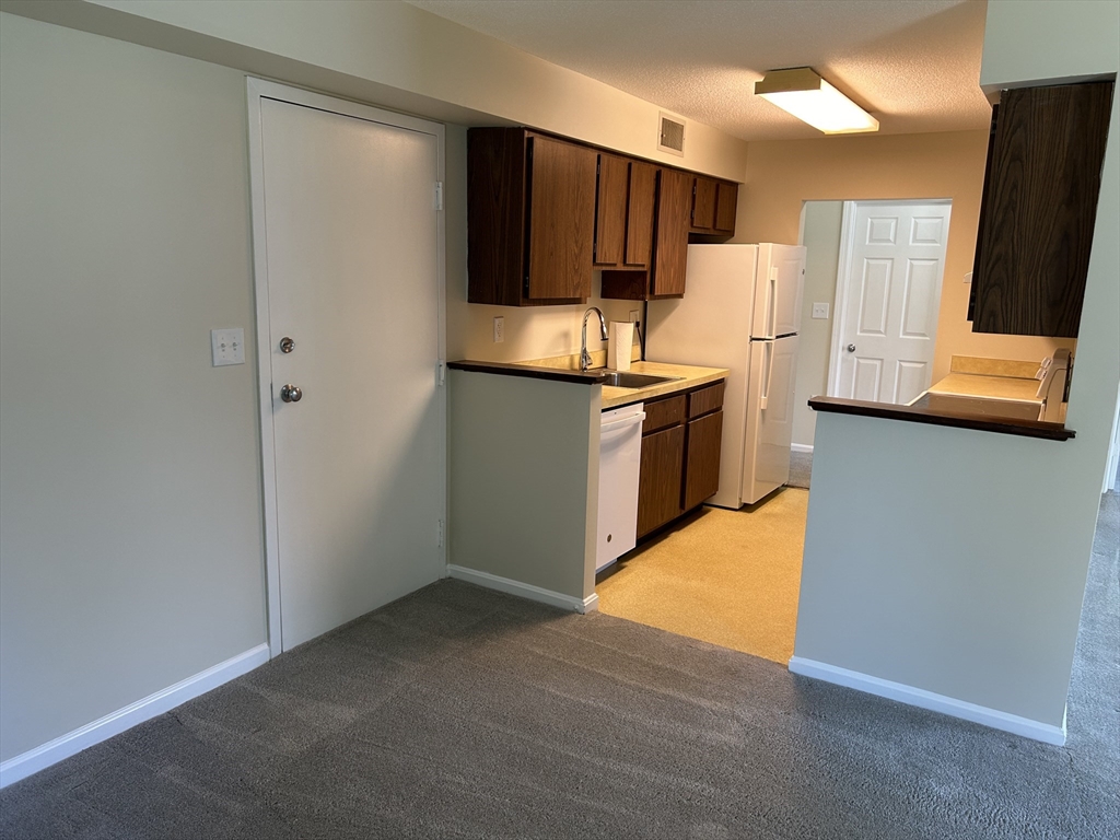 20 Beal's Cove Road, Unit A Hingham, MA 02043 - Photo 4 of 7 a kitchen with a refrigerator and a sink
