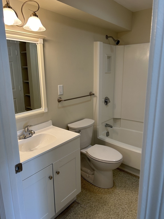 20 Beal's Cove Road, Unit A Hingham, MA 02043 - Photo 5 of 7 a bathroom with a toilet sink and mirror