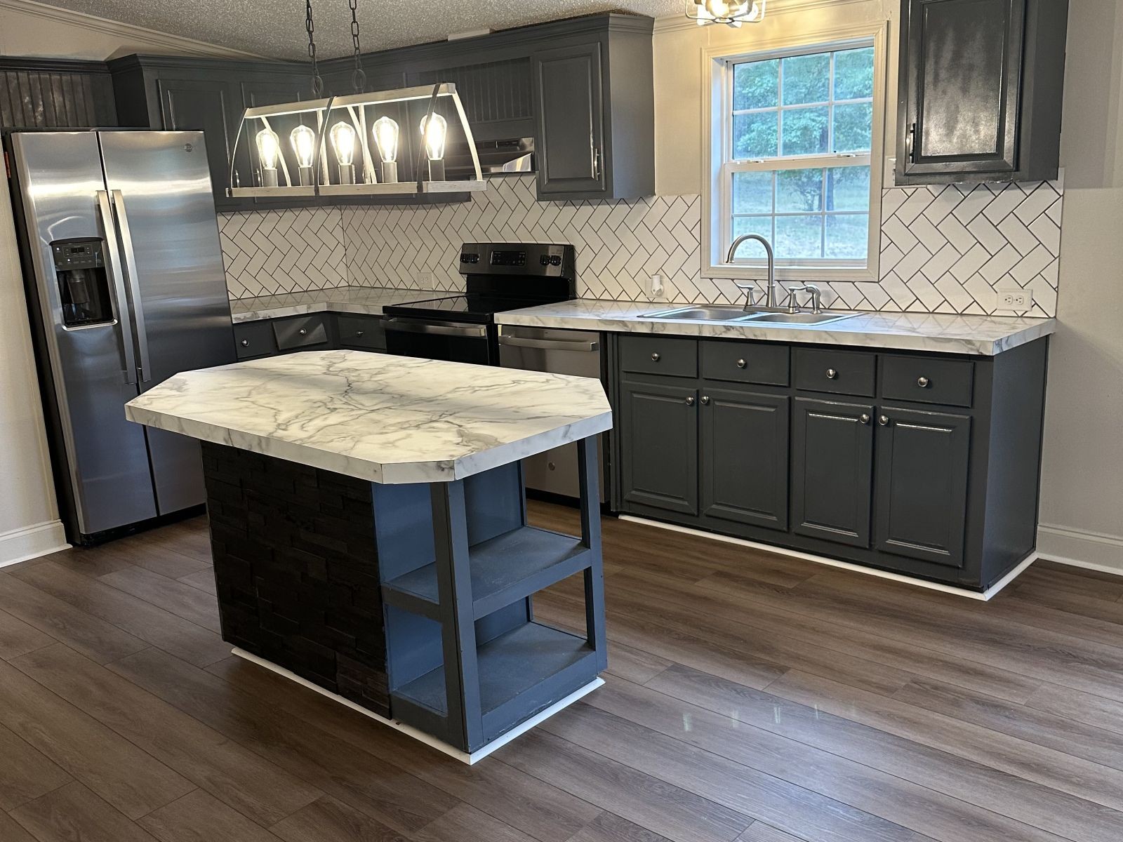 75 David Box Road Darden, TN 38328 - Photo 2 of 10 a kitchen with a sink a counter space stainless steel appliances and cabinets