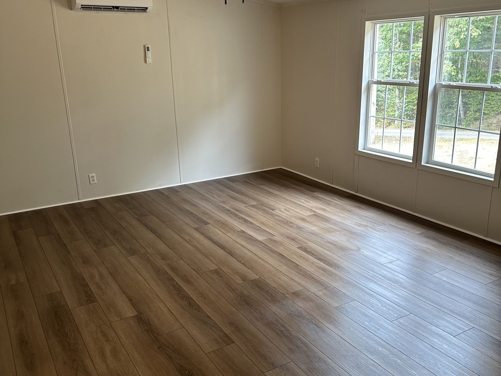 75 David Box Road Darden, TN 38328 - Photo 5 of 10 an empty room with wooden floor and windows