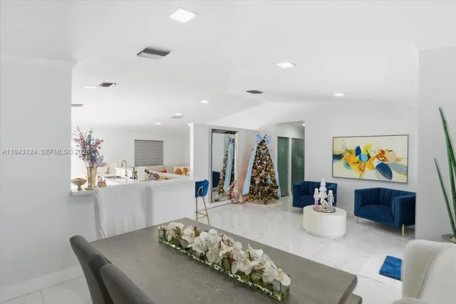 a very nice looking dining room with kitchen island furniture and a flat screen tv