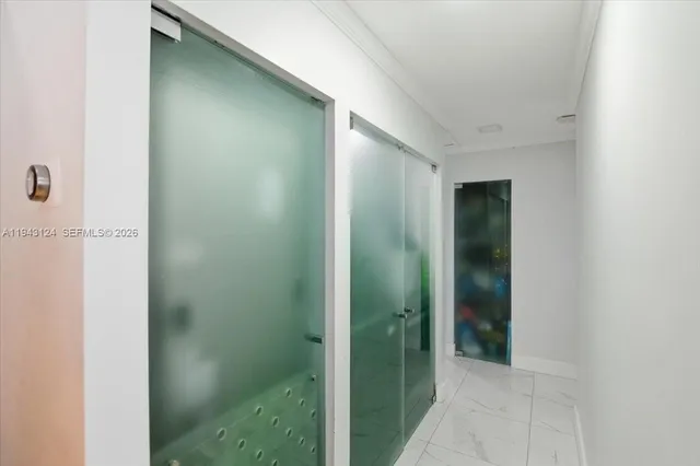 a bathroom with a glass shower door and a sink
