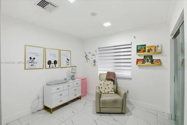 a living room with furniture and paintings on the wall