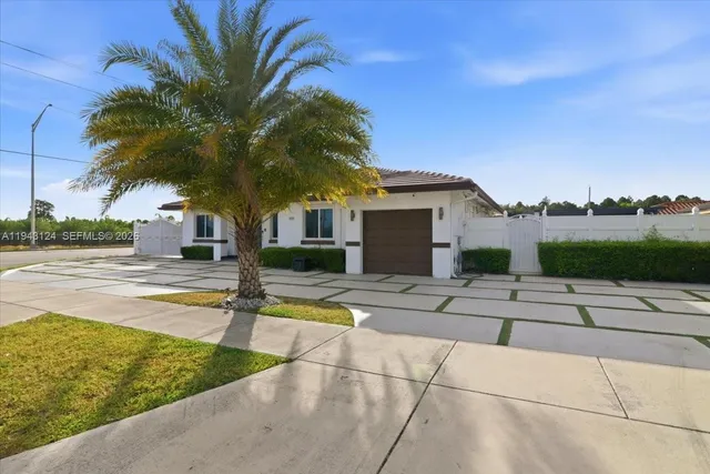 a view of a house with swimming pool and sitting area