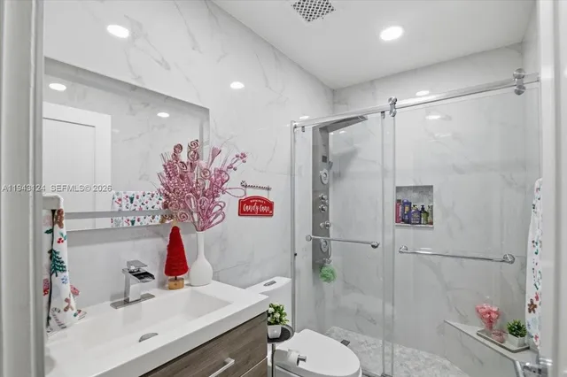 a bathroom with a sink toilet and shower