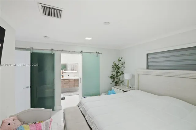 a bedroom with a bed and a potted plant