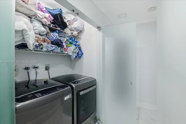 a close view of a utility room with dryer and washer