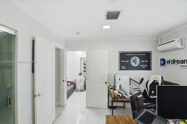 a view of a livingroom with furniture and workspace