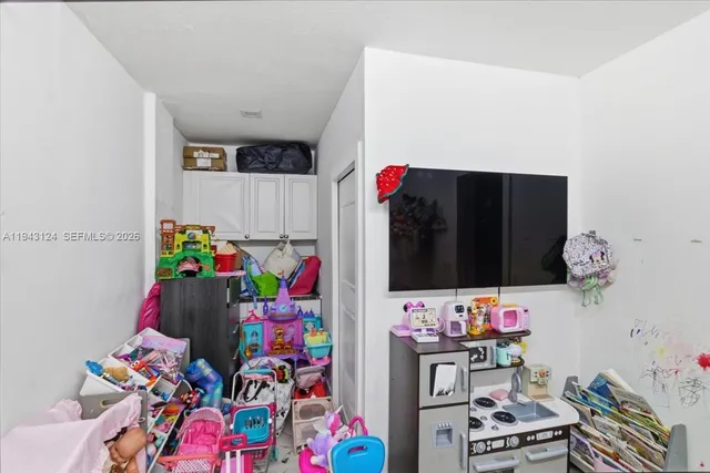 a room with toys and a baby crib