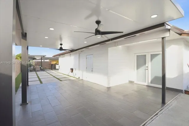 a view of a hallway with entryway and chandelier