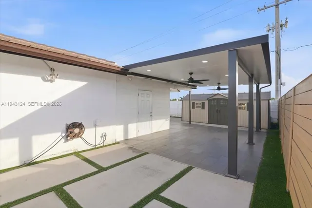 a view of a hallway to an empty room and wooden floor