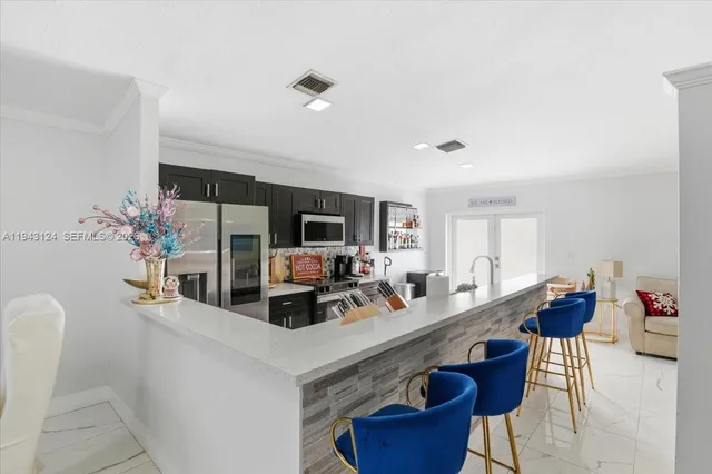 a view of living room filled with furniture and flat screen tv