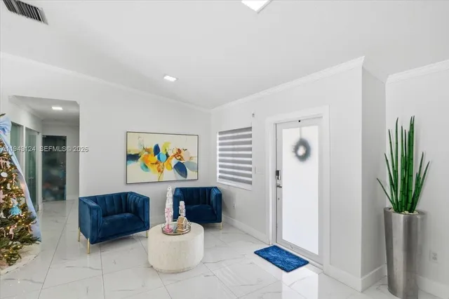 a living room with furniture a potted plant and a painting on the wall
