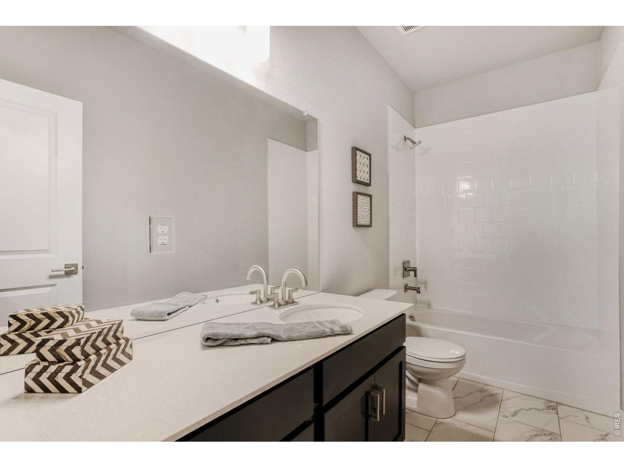 191 Buckwheat Lane Berthoud, CO 80513 - Photo 20 of 31 a bathroom with a granite countertop sink a toilet and shower