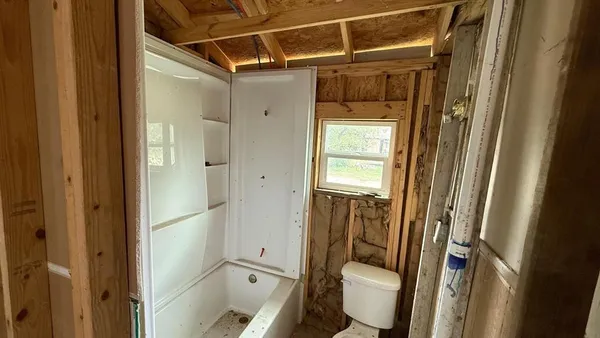 a bathroom with a toilet and a shower