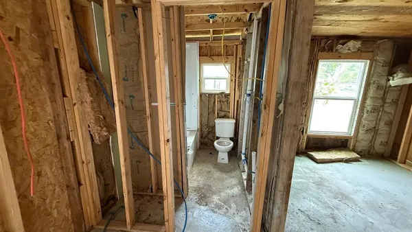 a view of a bathroom with a tub and shower