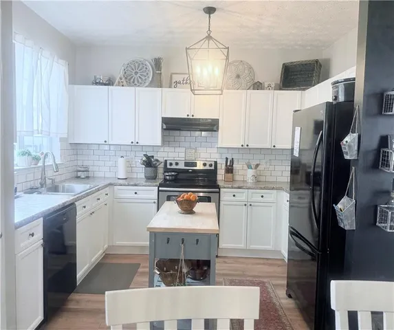 a kitchen with a stove a sink and a microwave