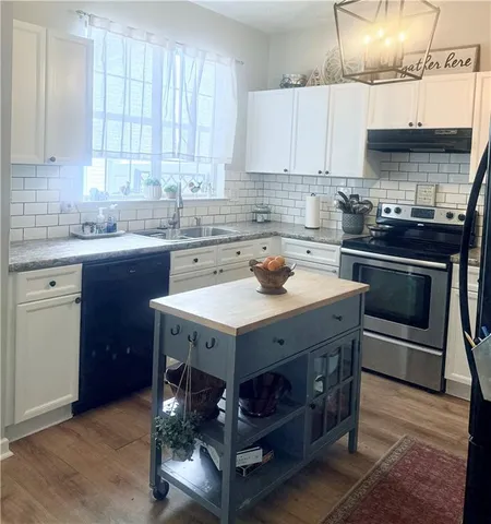 a living room with furniture flowerpot and wooden floor