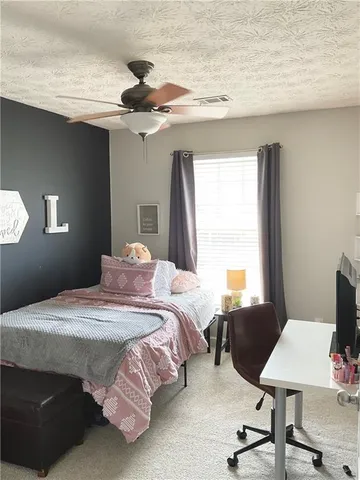 a bedroom with a bed and a chair