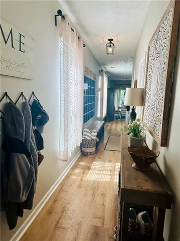 a view of hallway with stairs and wooden floor