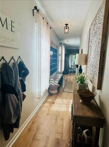 a view of hallway with stairs and wooden floor