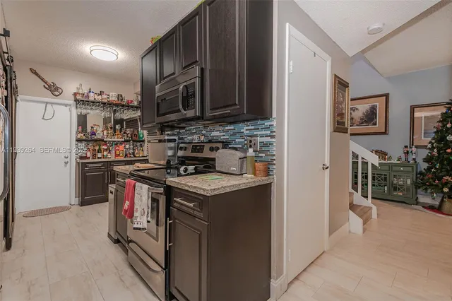 a kitchen with stainless steel appliances granite countertop a stove and a refrigerator