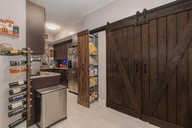 a kitchen with a refrigerator and cabinets