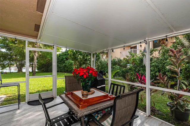 a balcony with wooden floor and outdoor seating