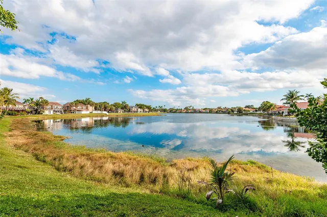 a view of a lake with houses in the back