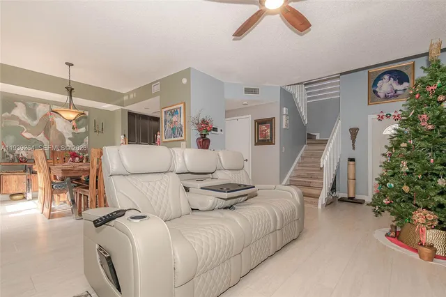 a living room with furniture and flowers
