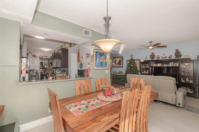 a living room with furniture a dining table and a chandelier