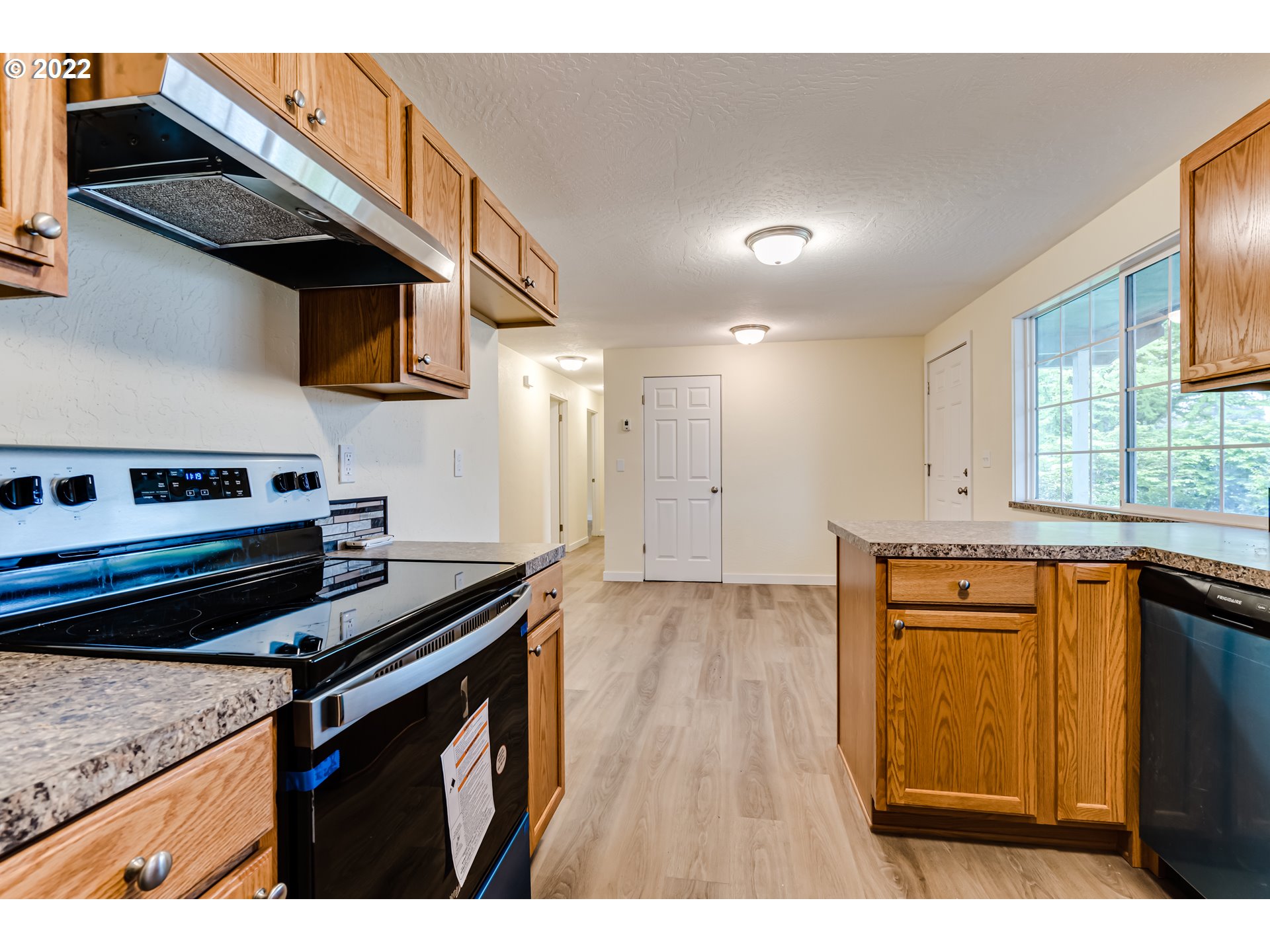 401 U Street Springfield, OR 97477 - Photo 15 of 29 a kitchen with stainless steel appliances granite countertop a stove a sink and a microwave