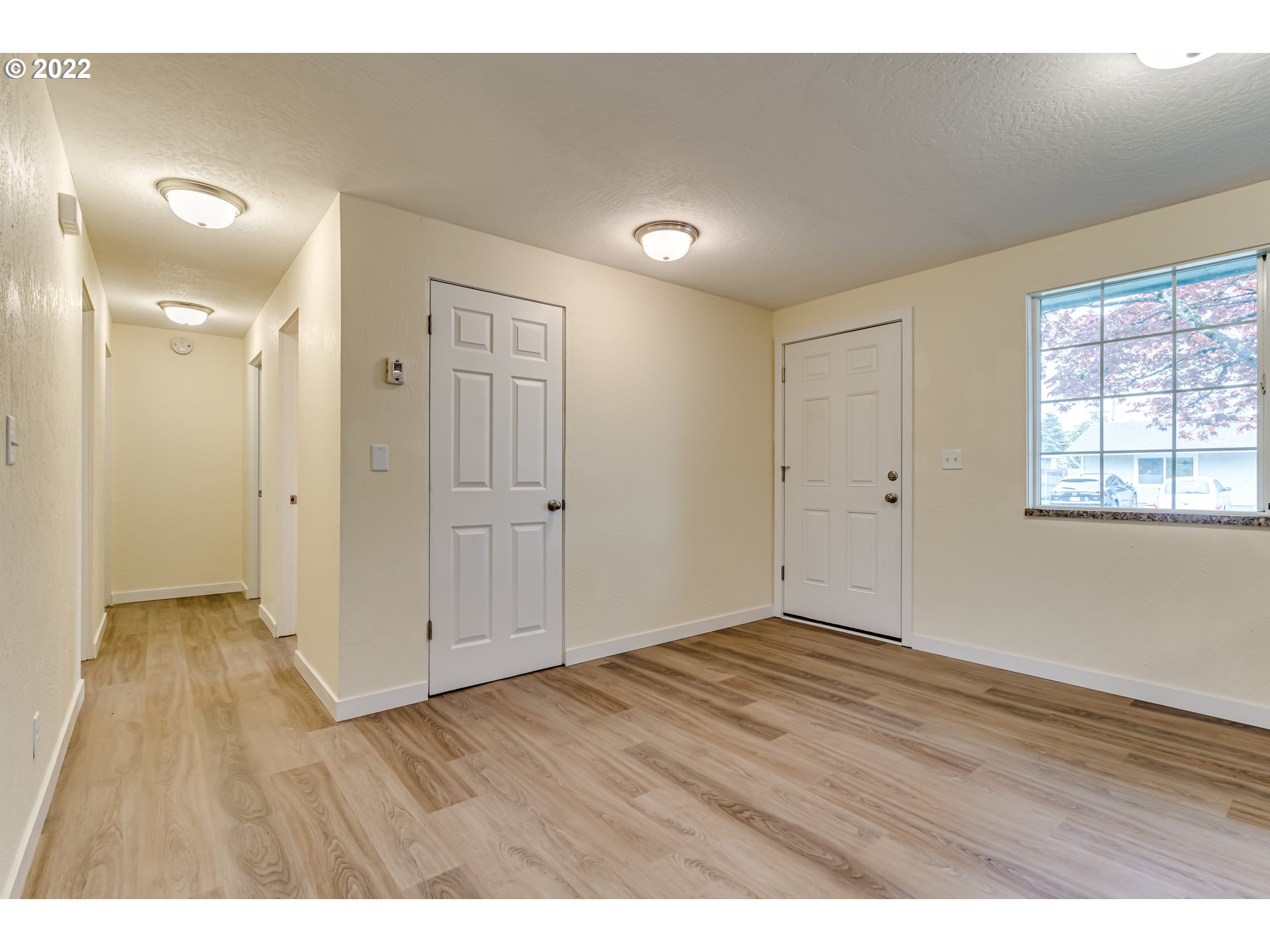 401 U Street Springfield, OR 97477 - Photo 8 of 29 an empty room with wooden floor and windows