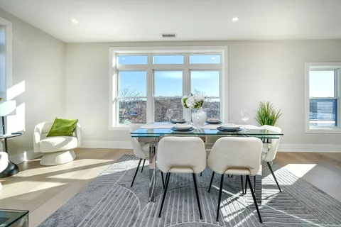 a dining room with furniture wooden floor and a chandelier