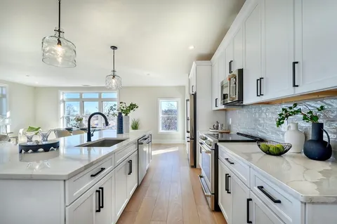 a kitchen with counter top space a sink and cabinets