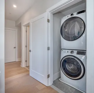 a view of a hallway with washer and dryer